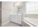 Bathroom features a vanity with storage and a luxurious corner bathtub at 111 Gingergate Dr, Cary, NC 27519