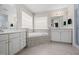Bathroom boasts double vanities, a garden tub, and tile floors at 111 Gingergate Dr, Cary, NC 27519