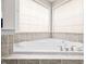 Close-up of the bathtub features tiled surround and updated fixtures at 111 Gingergate Dr, Cary, NC 27519