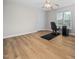 Bedroom featuring wood flooring, a ceiling fan, and a window providing natural light at 111 Gingergate Dr, Cary, NC 27519