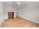 Bedroom with wood flooring, a ceiling fan, a doorway to an adjacent room and a wooden dresser at 111 Gingergate Dr, Cary, NC 27519