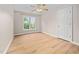 Bedroom with wood floors, neutral walls, a ceiling fan, a window and a door at 111 Gingergate Dr, Cary, NC 27519