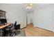 Bright bedroom with a ceiling fan, wood-look flooring, closet and adjacent office space at 111 Gingergate Dr, Cary, NC 27519