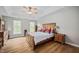 Light-filled bedroom has a tray ceiling, ceiling fan, and beautiful hardwood floors at 111 Gingergate Dr, Cary, NC 27519