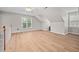 Bright bonus room offers wood-look floors, dormer windows, and a ceiling fan at 111 Gingergate Dr, Cary, NC 27519