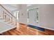Bright foyer with hardwood floors, a staircase, and a front door with sidelights at 111 Gingergate Dr, Cary, NC 27519
