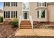 Inviting front entrance with brick steps leading to a classic black front door with sidelights at 111 Gingergate Dr, Cary, NC 27519