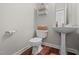 Compact half bathroom featuring pedestal sink and toilet at 111 Gingergate Dr, Cary, NC 27519