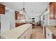 Open kitchen with island overlooks dining area and living room with hardwood floors at 111 Gingergate Dr, Cary, NC 27519