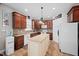 Well-lit kitchen featuring custom cabinets, tiled backsplash, island and modern appliances at 111 Gingergate Dr, Cary, NC 27519