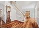 Elegant staircase with wooden banister, carpeted steps and beautiful hardwood floors at 111 Gingergate Dr, Cary, NC 27519