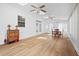Spacious sun room featuring skylights, ceiling fans and hardwood floors at 111 Gingergate Dr, Cary, NC 27519
