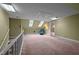 Attic with carpet, slanted ceilings, skylights, and chair, providing versatile living space at 12088 Burlington Rd, Hurdle Mills, NC 27541