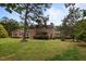 Expansive backyard featuring lush greenery and mature trees, providing a serene outdoor retreat at 12088 Burlington Rd, Hurdle Mills, NC 27541