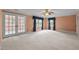 Spacious bedroom with many windows, French doors and carpet at 12088 Burlington Rd, Hurdle Mills, NC 27541