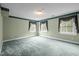 Bedroom featuring three windows with valances, green paint and carpet, offering ample natural light at 12088 Burlington Rd, Hurdle Mills, NC 27541