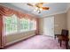 Bedroom featuring large window, neutral walls, and plush carpeting at 12088 Burlington Rd, Hurdle Mills, NC 27541