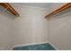 Walk-in closet with wooden shelves and teal carpet at 12088 Burlington Rd, Hurdle Mills, NC 27541