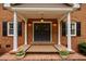 Inviting front entrance with brick columns, double doors, and elegant lighting at 12088 Burlington Rd, Hurdle Mills, NC 27541
