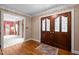 Spacious foyer with hardwood floors, ornate glass-paneled doors, and bright lighting at 12088 Burlington Rd, Hurdle Mills, NC 27541