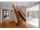 Open foyer featuring hardwood floors, staircase, and access to multiple rooms at 12088 Burlington Rd, Hurdle Mills, NC 27541
