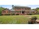 Stately brick home with classic black shutters and a welcoming front entrance and landscaped front yard at 12088 Burlington Rd, Hurdle Mills, NC 27541