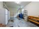 Spacious garage with storage shelves, refrigerator, and ample room for parking at 12088 Burlington Rd, Hurdle Mills, NC 27541
