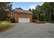 Exterior view of a brick two-story home with a two-car garage and driveway at 12088 Burlington Rd, Hurdle Mills, NC 27541
