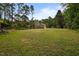 Spacious front yard leading to a charming brick home, nestled among tall trees at 12088 Burlington Rd, Hurdle Mills, NC 27541