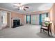 Spacious living room features a fireplace with black marble and a ceiling fan at 12088 Burlington Rd, Hurdle Mills, NC 27541