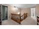 Charming stairway with wooden railings and chandelier overhead at 12088 Burlington Rd, Hurdle Mills, NC 27541