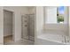 The primary bathroom has a soaking tub and a glass enclosed shower at 121 Gilmer St, Fuquay Varina, NC 27526