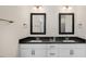 Elegant bathroom features double sinks with black countertops and white cabinets with bronze hardware at 121 Gilmer St, Fuquay Varina, NC 27526