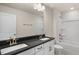 Bathroom featuring a double sink vanity with gray countertop and shower-tub combo at 121 Gilmer St, Fuquay Varina, NC 27526