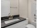 Bathroom featuring a gray countertop, white cabinets, and a shower-tub combo at 121 Gilmer St, Fuquay Varina, NC 27526