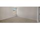 Bedroom with neutral walls, carpet, and a window offering neighborhood views at 121 Gilmer St, Fuquay Varina, NC 27526