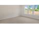 This bedroom features plush carpeting, neutral walls, and a large window at 121 Gilmer St, Fuquay Varina, NC 27526