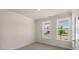 Bedroom with neutral walls, carpet, and two windows with neighborhood views at 121 Gilmer St, Fuquay Varina, NC 27526