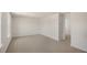 Spacious bedroom with neutral carpet, walls, and doorway to a hallway at 121 Gilmer St, Fuquay Varina, NC 27526