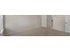 Bedroom features neutral carpet, walls, and doorway to a hallway at 121 Gilmer St, Fuquay Varina, NC 27526
