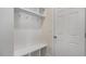 Entryway showing the built-in coat rack, storage, and hooks next to a white door at 121 Gilmer St, Fuquay Varina, NC 27526