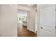 Hallway view opening to the kitchen with stainless steel appliances, white cabinetry, and dark countertops at 121 Gilmer St, Fuquay Varina, NC 27526