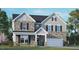 Charming two-story home featuring stone and vinyl siding, a covered porch, and a two-car garage at 121 Gilmer St, Fuquay Varina, NC 27526