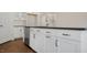 This modern kitchen features white cabinets, sleek countertops, and stainless steel appliances at 121 Gilmer St, Fuquay Varina, NC 27526