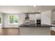 Modern kitchen featuring stainless steel appliances, white cabinets, and dark countertops with island seating at 121 Gilmer St, Fuquay Varina, NC 27526