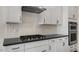 This kitchen boasts white cabinets, stainless steel appliances, and sleek countertops at 121 Gilmer St, Fuquay Varina, NC 27526