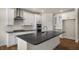 Modern kitchen featuring stainless steel appliances, white cabinets, and dark countertops at 121 Gilmer St, Fuquay Varina, NC 27526