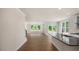 Bright open-concept living area with wood floors, and a view into the backyard at 121 Gilmer St, Fuquay Varina, NC 27526