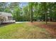 Expansive backyard with lush lawn, swimming pool, and mature trees providing privacy at 12301 Hardee Rd, Raleigh, NC 27614