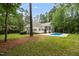 Backyard featuring in-ground pool, wooden deck, and spacious lawn area at 12301 Hardee Rd, Raleigh, NC 27614